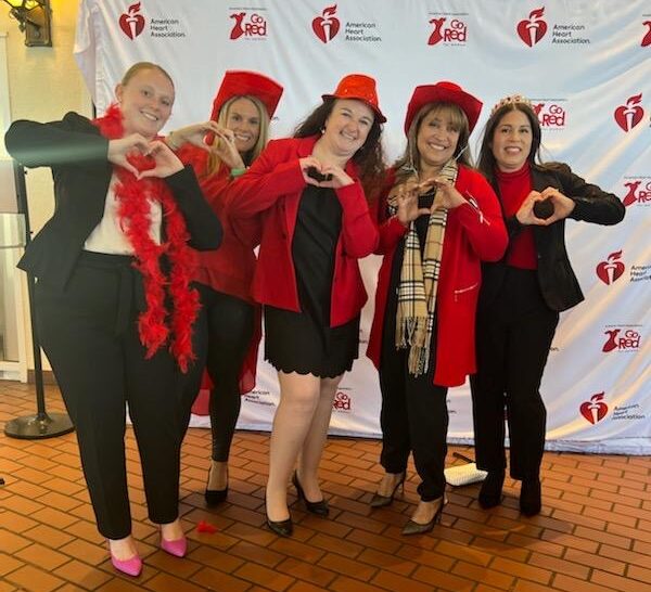 YMCA of CNW American Heart Association's Go Red For Women dinner Group photo heart hands